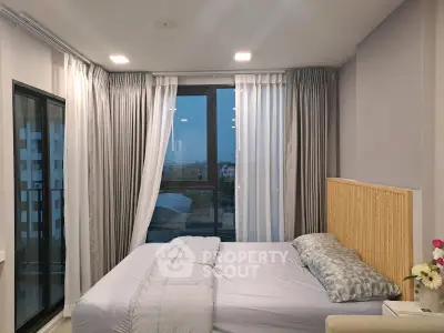 Modern bedroom with large window and stylish decor in urban apartment