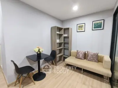 Modern living room with cozy sofa, stylish chairs, and elegant decor in a contemporary apartment.
