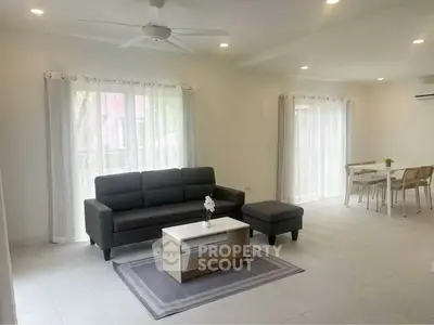 Spacious modern living room with sleek furniture and natural light