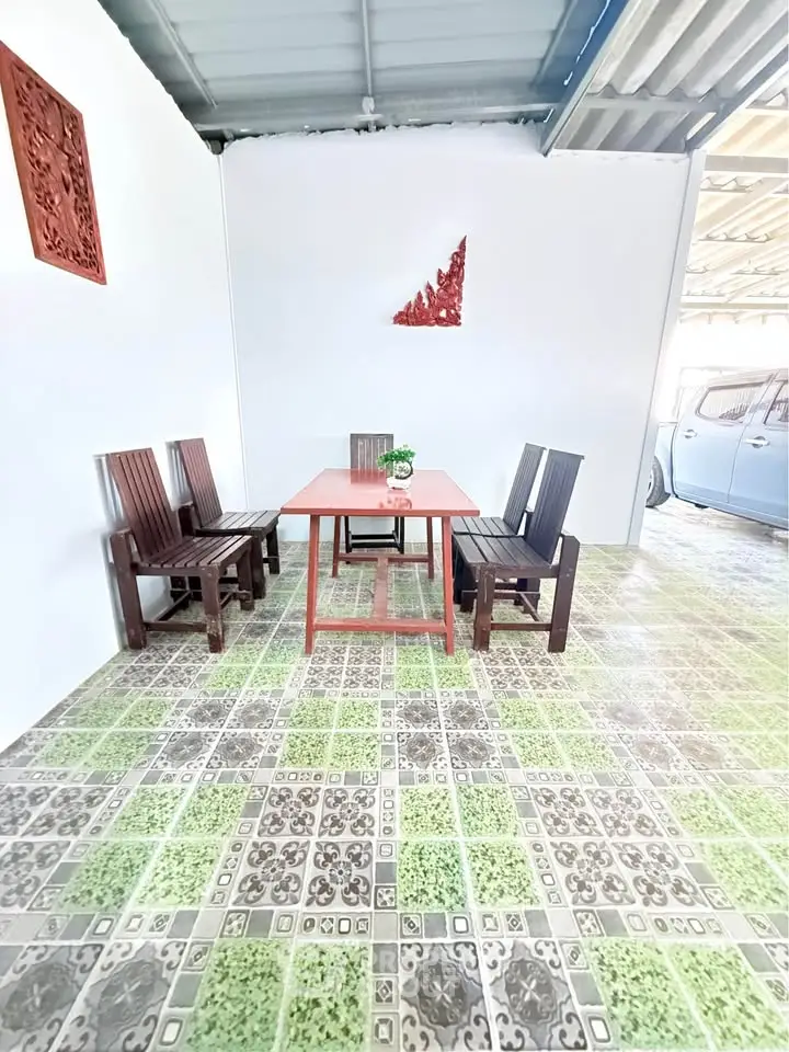 Charming outdoor seating area with rustic wooden furniture and decorative wall art, perfect for relaxation.