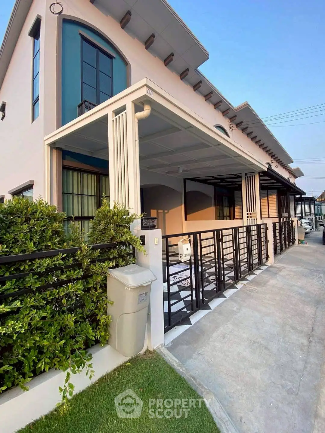 Modern two-story house with sleek design and spacious driveway