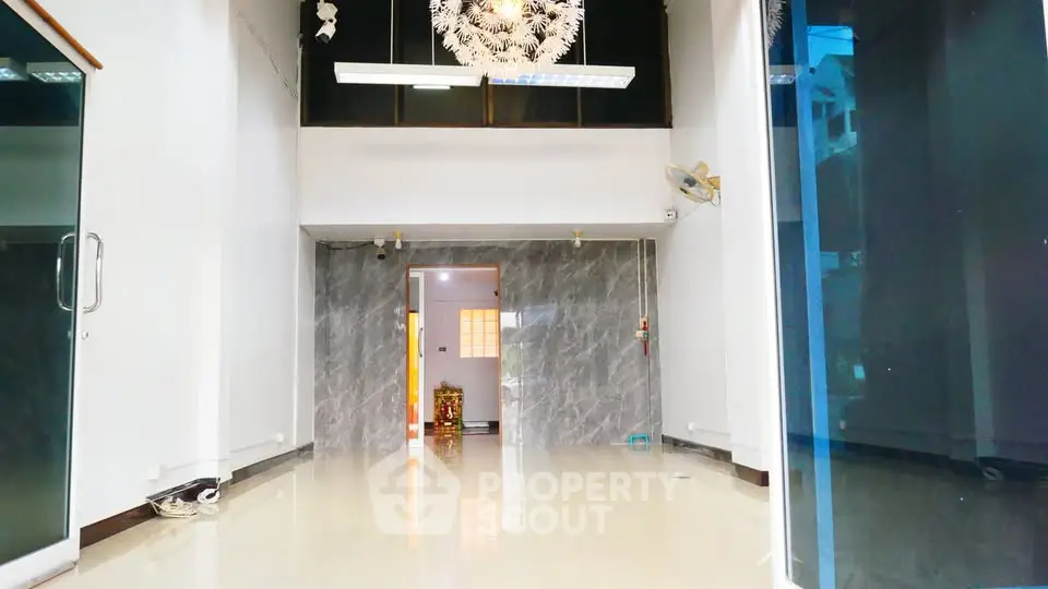 Spacious modern interior with high ceilings and elegant lighting, perfect for versatile living or commercial use.