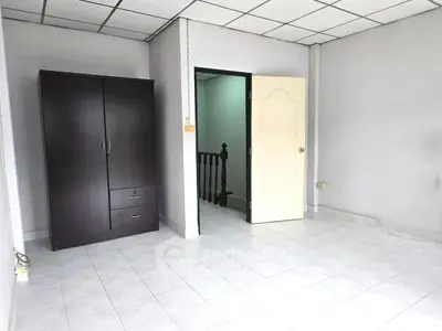 Spacious empty room with wardrobe and tiled flooring
