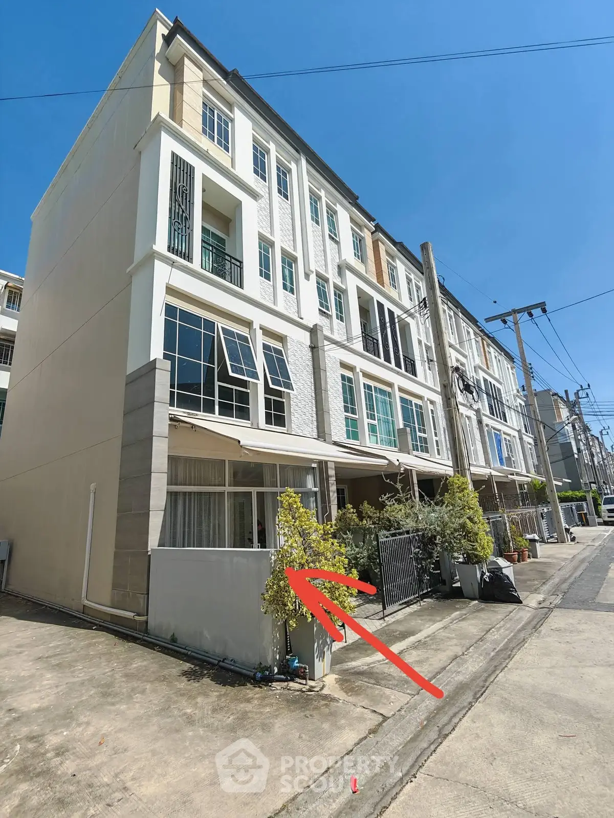 Modern multi-story townhouse with clean facade and sunny exterior