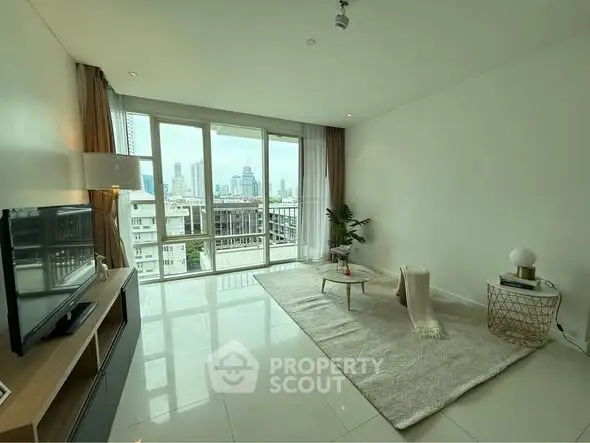 Spacious modern living room with city view, large windows, and elegant decor.