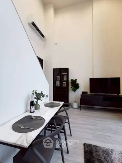 Modern living room with high ceilings, sleek furniture, and minimalist decor