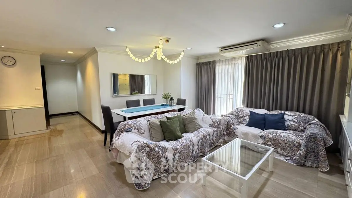 Spacious living room with elegant decor and ample natural light in a modern apartment.