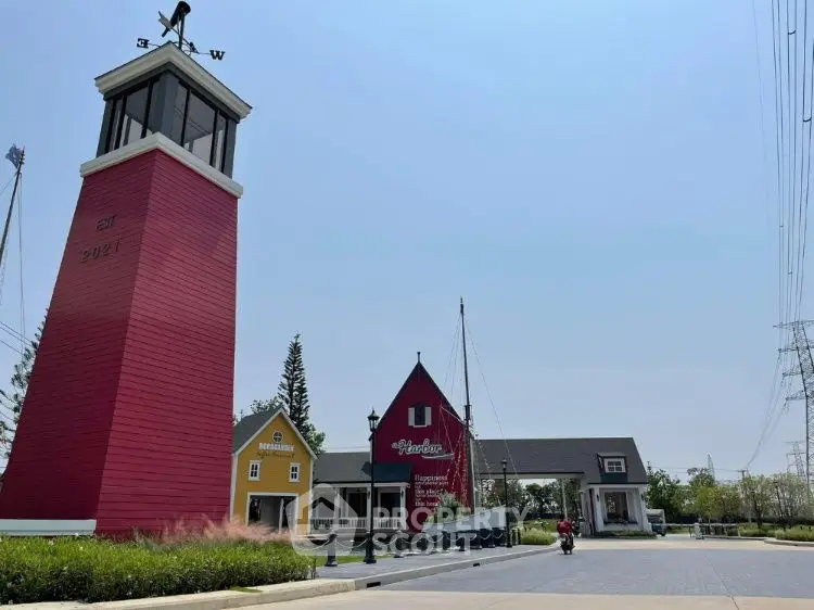 Charming exterior view of colorful buildings with lighthouse and clear sky