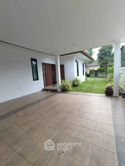 Spacious covered patio with garden view in modern home