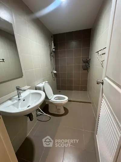 Modern bathroom with sleek fixtures and neutral tiles