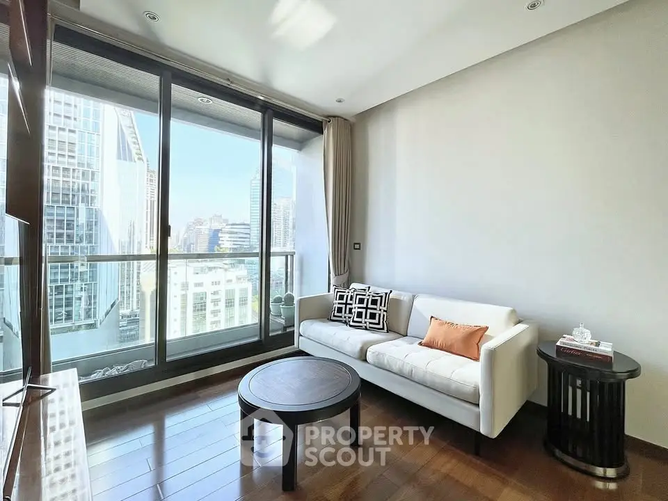 Modern living room with city view, featuring sleek furniture and floor-to-ceiling windows.