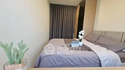 Cozy bedroom with modern decor and soft lighting, featuring a comfortable bed and stylish curtains.