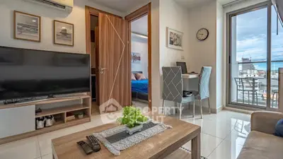 Modern living room with balcony view, stylish decor, and cozy atmosphere in urban apartment.