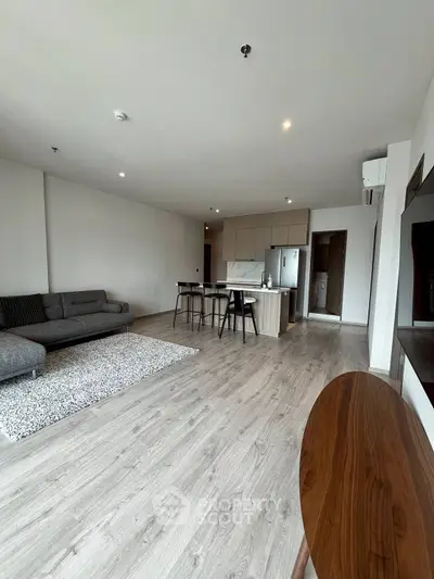 Spacious modern living room with open kitchen and stylish furnishings