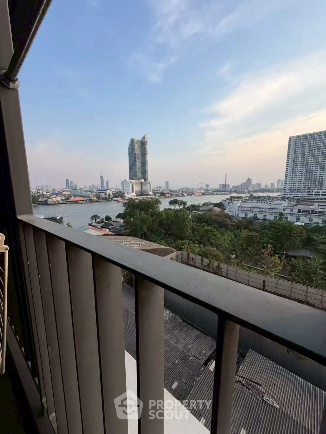 Stunning cityscape view from a high-rise balcony overlooking the river and skyline.
