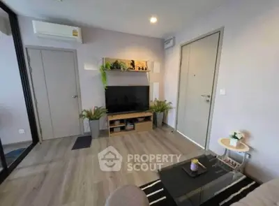 Modern living room with sleek decor and wall-mounted TV, perfect for relaxation and entertainment.