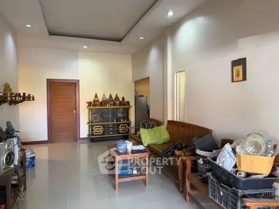 Spacious living room with modern decor and ample natural light, perfect for relaxation and entertainment.