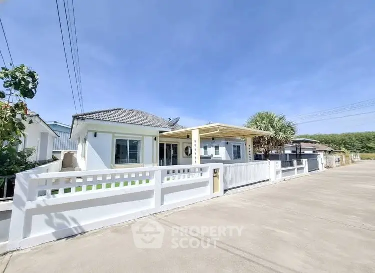 Charming single-story home with spacious driveway and modern exterior design.