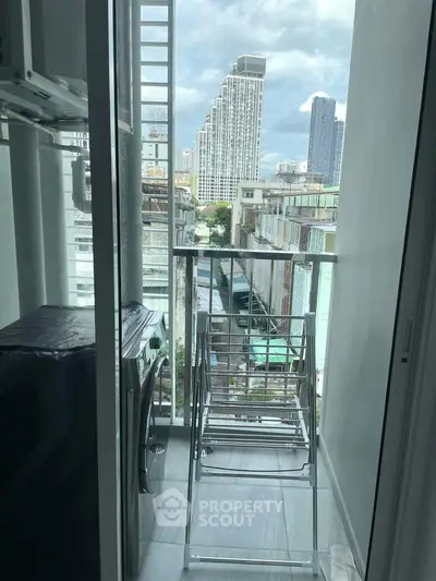 Modern balcony with city view, featuring laundry area and drying racks, perfect for urban living.