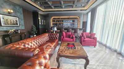 Luxurious living room with leather sofa and elegant bar setup, perfect for entertaining.