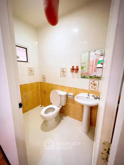 Cozy bathroom with modern fixtures and tiled walls, perfect for a comfortable living experience.