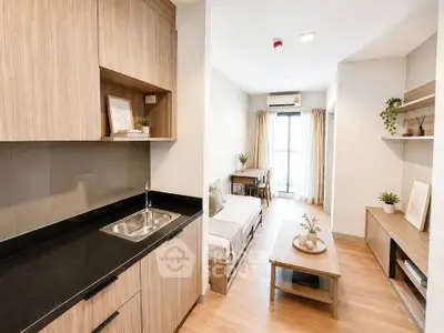 Modern open-layout living room with kitchen in stylish apartment