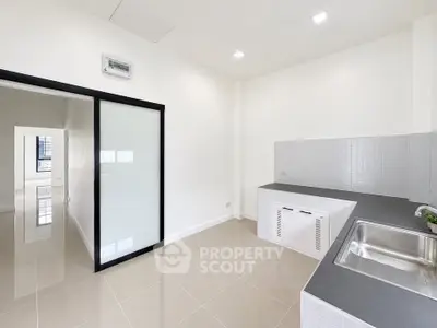 Modern kitchen with sleek countertops and open layout in a bright apartment.