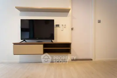 Modern living room with mounted TV and sleek shelving unit