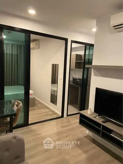 Modern apartment interior with living room, bedroom, and kitchen view
