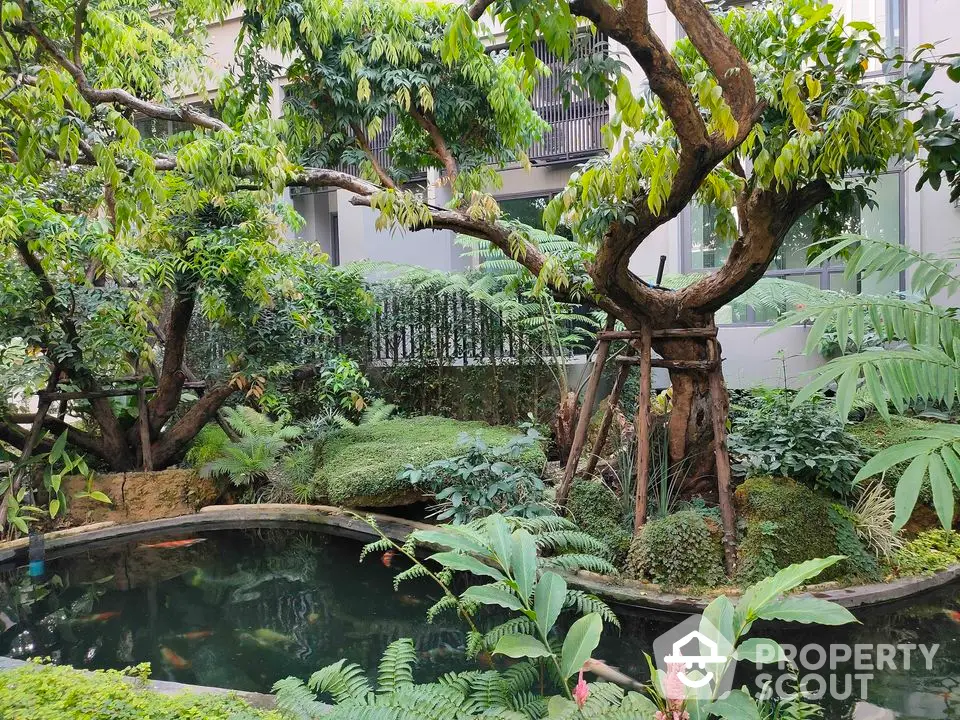 Lush garden with koi pond in modern residential complex