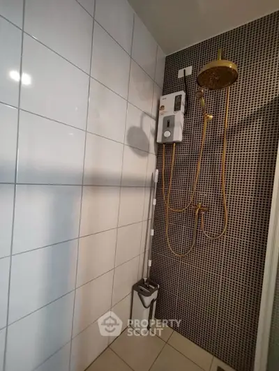 Modern bathroom with stylish shower and tiled walls