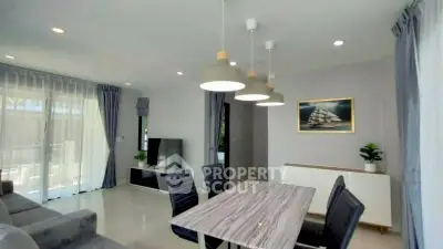 Modern living room with stylish dining area and natural light