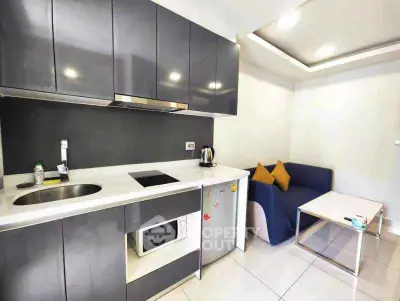Modern compact kitchen with sleek cabinetry and cozy seating area