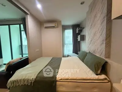 Cozy bedroom with modern decor and balcony view