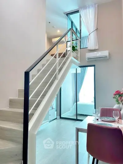 Modern duplex apartment with stylish staircase and bright open living area