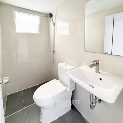 Modern minimalist bathroom with sleek fixtures and neutral tiles