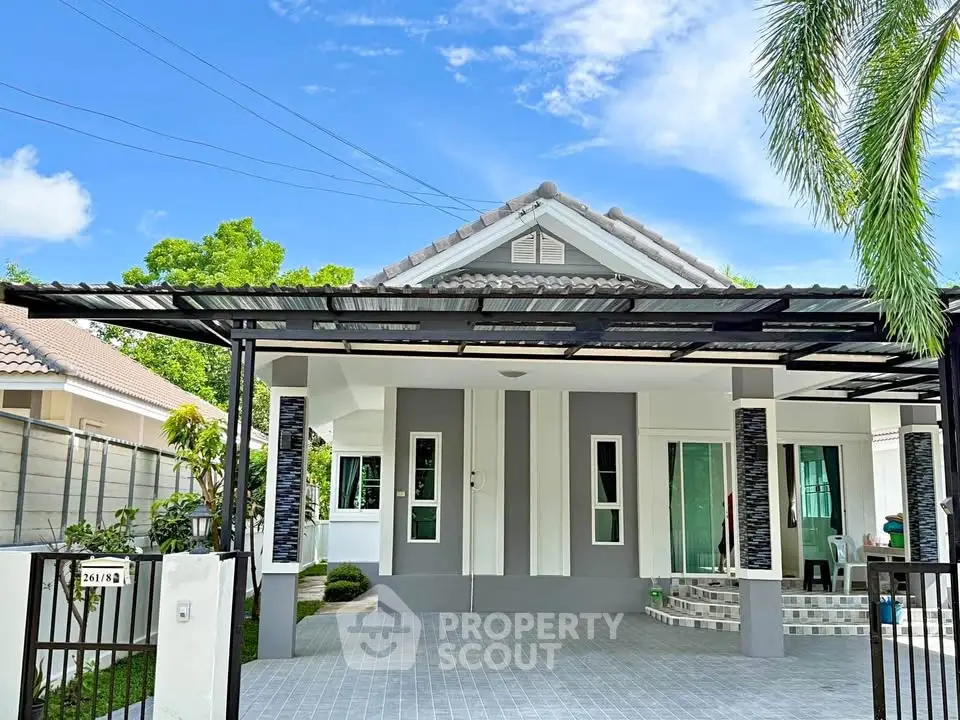 Charming single-story home with modern facade and spacious driveway