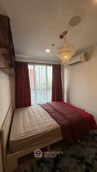 Cozy bedroom with elegant chandelier and large window view