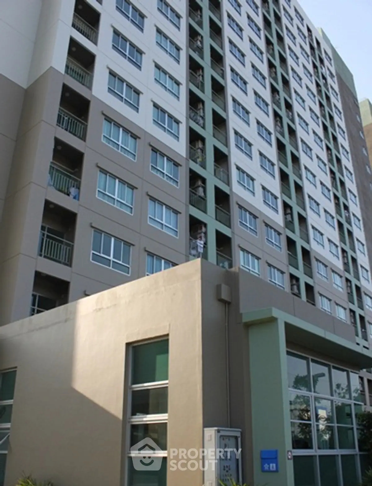 Modern high-rise apartment building with large windows and balconies