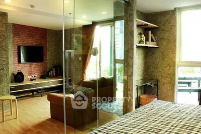 Modern living room with glass partition and stylish decor