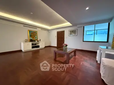 Spacious living room with elegant wooden flooring and modern decor