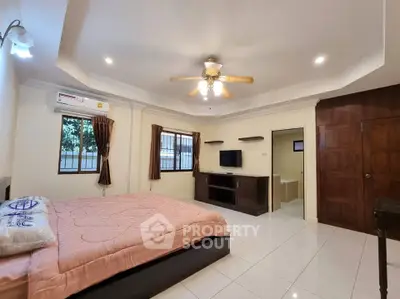Spacious bedroom with ceiling fan and modern amenities