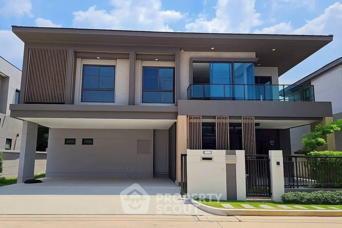 Modern two-story house with sleek design and spacious balcony in a serene neighborhood.