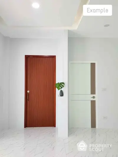 Modern minimalist interior with white walls, marble flooring, and contrasting wooden door.