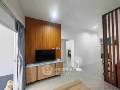 Modern living room with wooden accents and sleek furniture in a contemporary apartment.