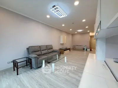 Spacious modern living room with sleek furniture and elegant lighting