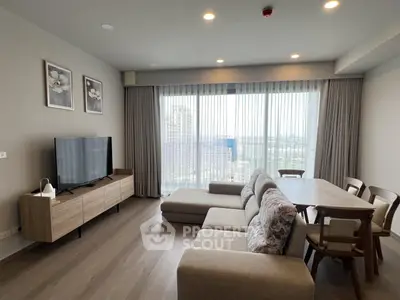 Spacious modern living room with large windows and stylish furniture, offering a bright and inviting atmosphere.