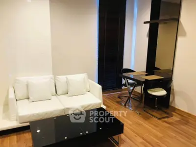 Modern living room with sleek furniture and wooden flooring