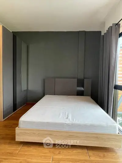 Modern bedroom with sleek design and large window for natural light