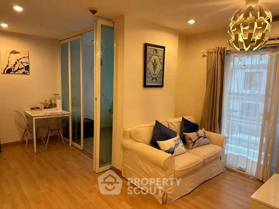 Cozy living room with modern decor and natural light in a stylish apartment.